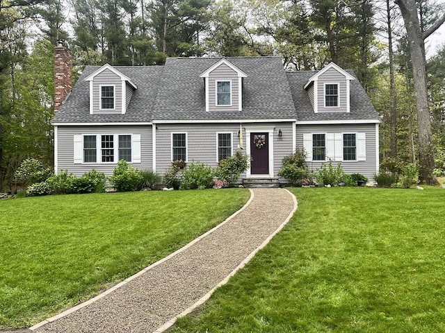 101 Titicut Rd, Raynham, MA 02767 - cape cod house with roof with shingles, a front lawn, and a chimney