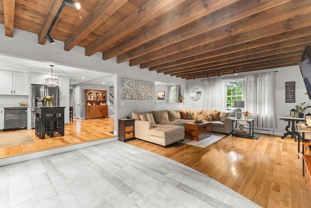 101 Titicut Rd, Raynham, MA 02767 - living area with light wood finished floors, wooden ceiling with exposed beams, and a chandelier