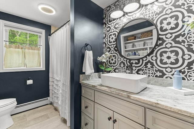 101 Titicut Rd, Raynham, MA 02767 - bathroom featuring a baseboard heating unit, toilet, vanity, wood finished floors, and baseboards
