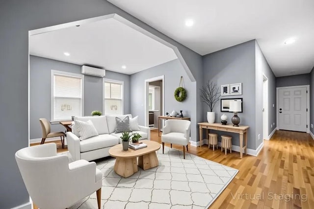 5 Sutton St Unit 3B, Boston, MA 02126 - living room featuring an AC wall unit, light wood-style flooring, baseboards, and recessed lighting