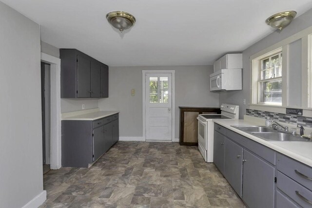 82 Grove St, North Brookfield, MA 01535 - kitchen featuring white appliances, a sink, baseboards, stone finish floors, and light countertops
