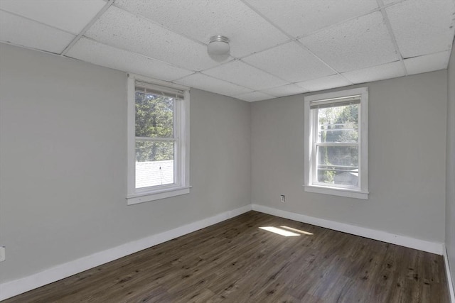82 Grove St, North Brookfield, MA 01535 - empty room with baseboards, a drop ceiling, and dark wood-type flooring