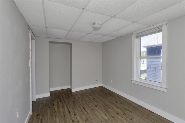 82 Grove St, North Brookfield, MA 01535 - spare room featuring dark wood-style flooring, a paneled ceiling, and baseboards