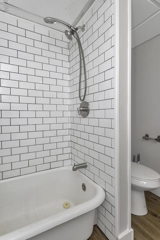 82 Grove St, North Brookfield, MA 01535 - full bath with toilet, wood finished floors, and shower / washtub combination