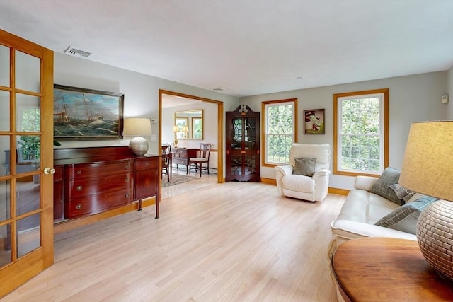 living area featuring light wood finished floors and baseboards