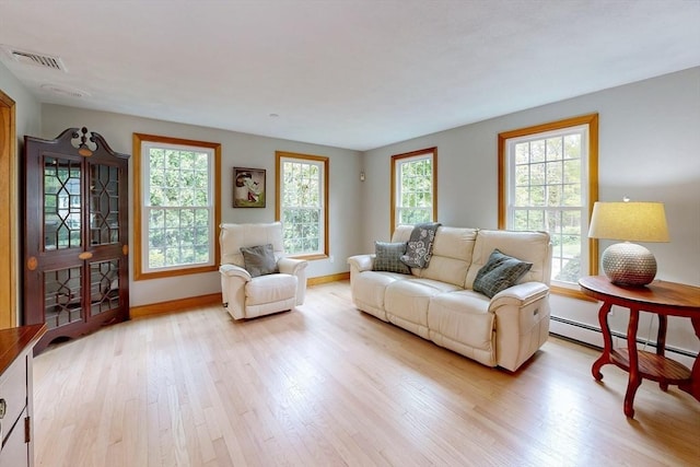 living room with light wood-type flooring and baseboards