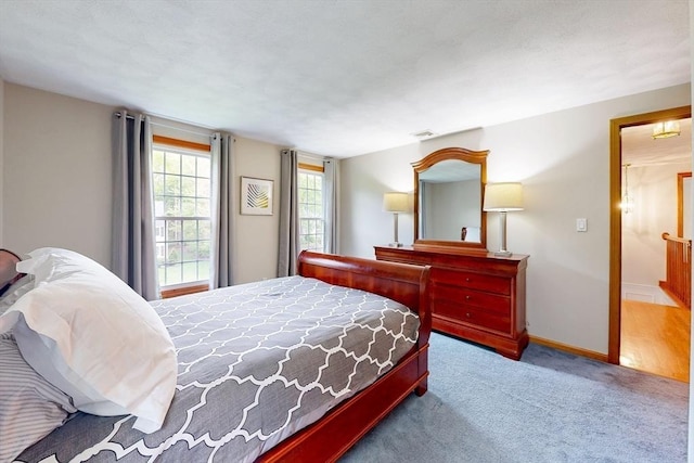 carpeted bedroom with baseboards