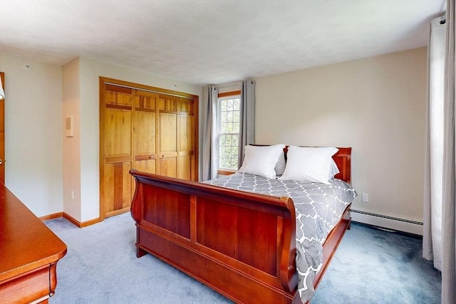 bedroom featuring a baseboard radiator, carpet floors, baseboards, and a closet