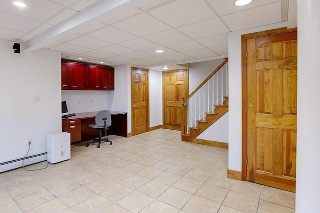 unfurnished office with built in desk, recessed lighting, a drop ceiling, baseboards, and light tile patterned floors