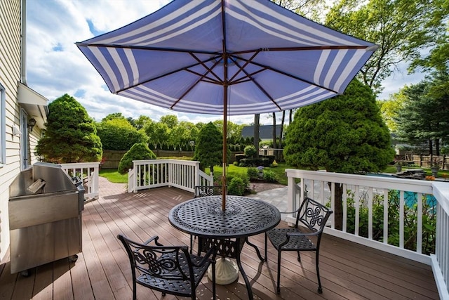wooden deck with fence and view of scattered trees