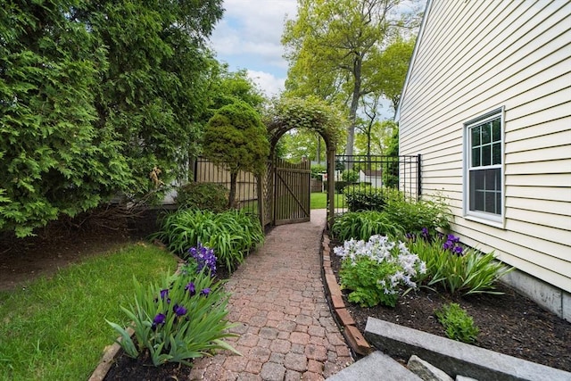 view of yard featuring fence and a gate
