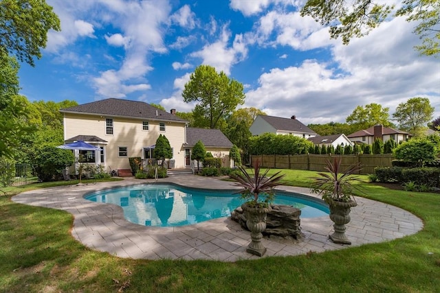 view of pool with a wooden deck and a patio