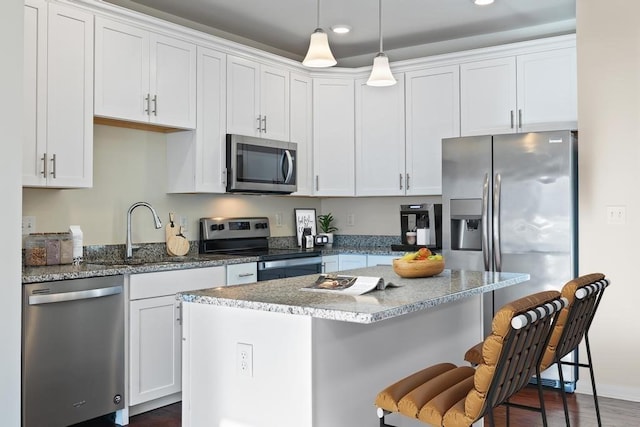 kitchen with white cabinetry, sink, a kitchen island, and stainless steel appliances