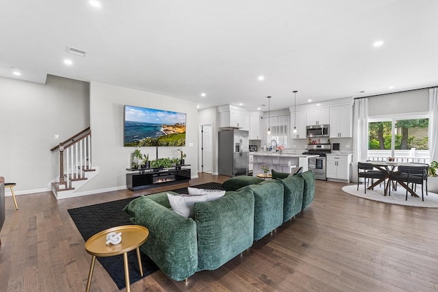 105 Depot St Unit A, Milford, MA 01757 - living room featuring stairs, recessed lighting, dark wood-style floors, and baseboards