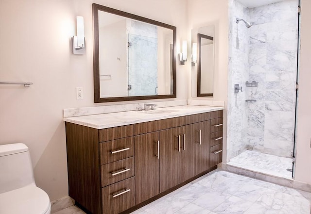 bathroom with vanity, toilet, and a tile shower