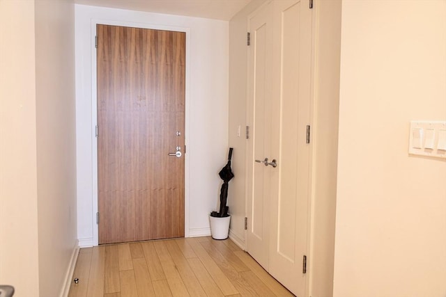 corridor with light wood-type flooring