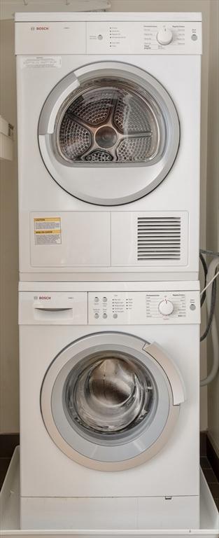 laundry area featuring stacked washer and dryer