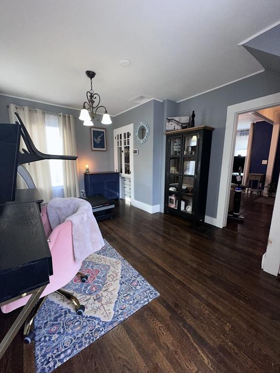 interior space with dark hardwood / wood-style floors and an inviting chandelier