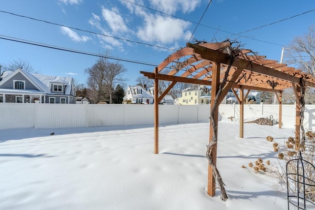 snowy yard featuring a pergola