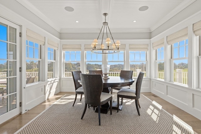 sunroom / solarium with a notable chandelier