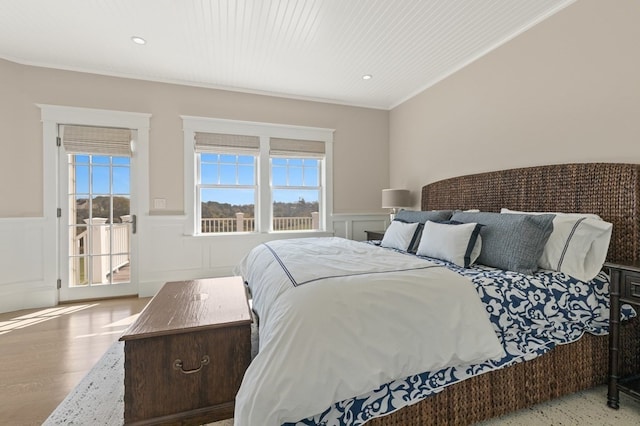 bedroom featuring crown molding and light hardwood / wood-style floors