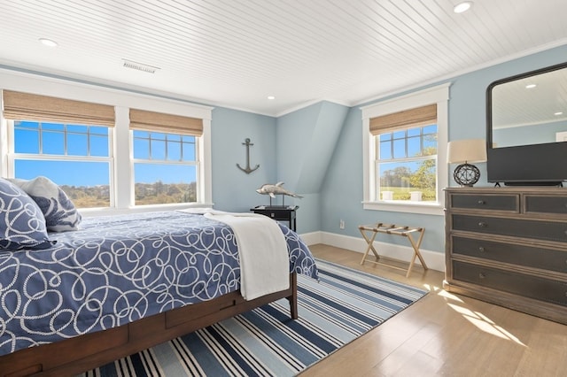 bedroom with wood ceiling, crown molding, and wood-type flooring