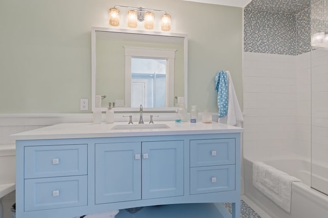 bathroom featuring vanity and tiled shower / bath