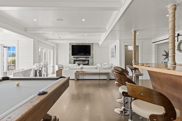 game room featuring beamed ceiling, dark hardwood / wood-style floors, a fireplace, and billiards