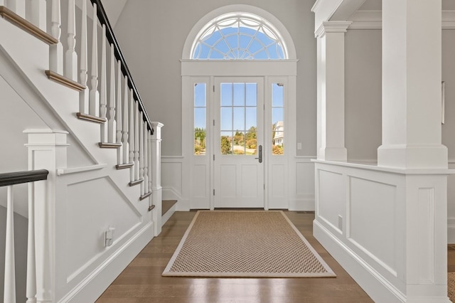 entryway featuring a wealth of natural light, dark hardwood / wood-style flooring, and a towering ceiling