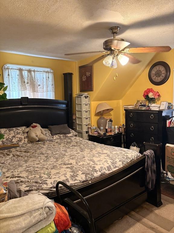 12 Graves Ave, Lynn, MA 01902 - carpeted bedroom featuring a textured ceiling and ceiling fan