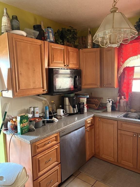 12 Graves Ave, Lynn, MA 01902 - kitchen featuring black microwave, stainless steel dishwasher, a chandelier, backsplash, and a sink