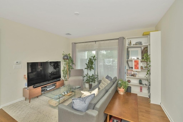 110 Trotter Rd Unit 104, Weymouth, MA 02190 - living area featuring wood finished floors and baseboards