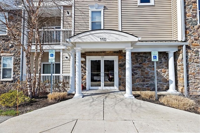 110 Trotter Rd Unit 104, Weymouth, MA 02190 - entrance to property with a balcony, stone siding, and a porch