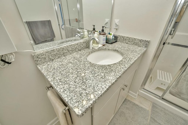 110 Trotter Rd Unit 104, Weymouth, MA 02190 - bathroom with a shower stall, vanity, and tile patterned floors