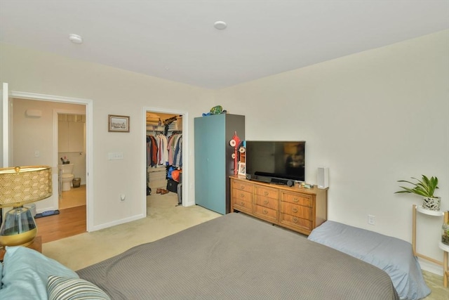 110 Trotter Rd Unit 104, Weymouth, MA 02190 - bedroom with a walk in closet, a closet, and light colored carpet