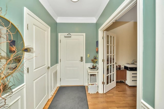 110 Trotter Rd Unit 104, Weymouth, MA 02190 - doorway with light wood-type flooring, ornamental molding, and wainscoting