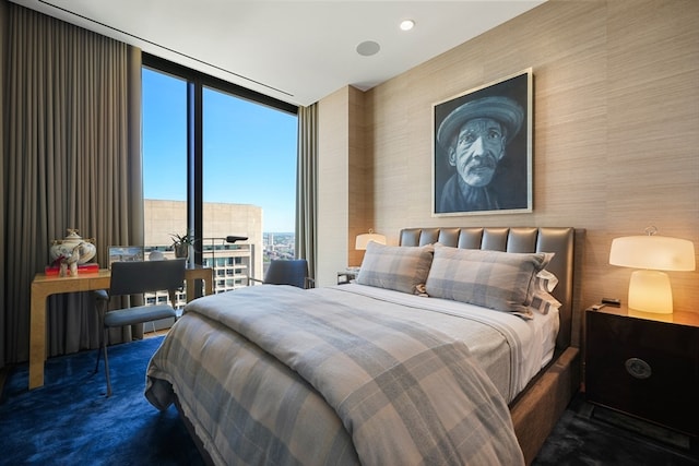 carpeted bedroom featuring a wall of windows