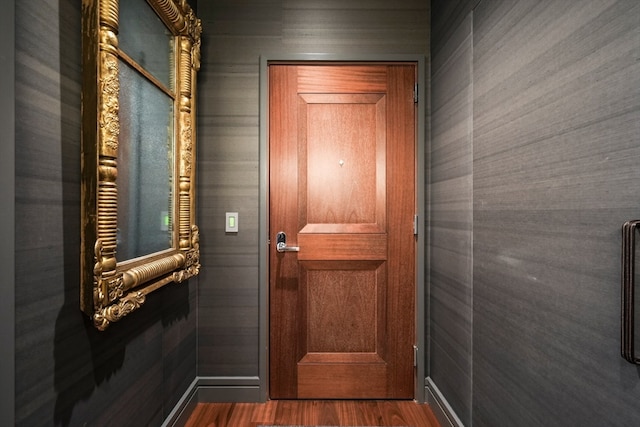 entryway with dark hardwood / wood-style floors and tile walls