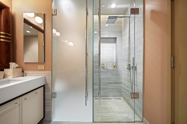 bathroom with vanity, an enclosed shower, and tile patterned flooring