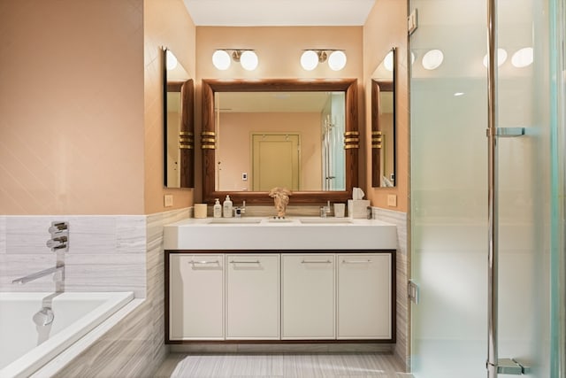 bathroom featuring shower with separate bathtub, vanity, tile patterned flooring, and tile walls