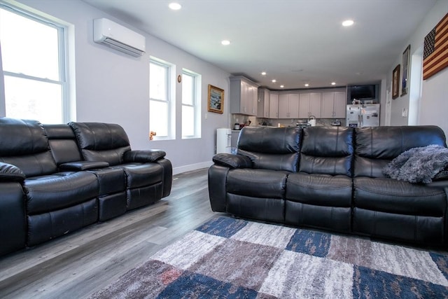 32 Leverett Rd, Shutesbury, MA 01072 - living room featuring a wall unit AC, wood finished floors, recessed lighting, and baseboards