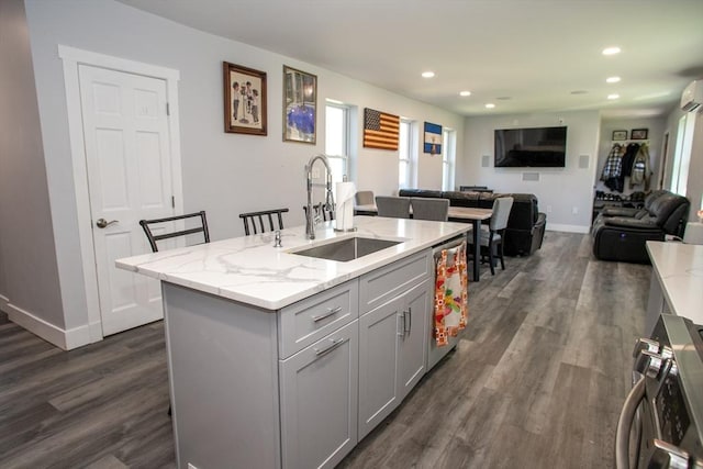 32 Leverett Rd, Shutesbury, MA 01072 - kitchen featuring a sink, dark wood-type flooring, gray cabinets, recessed lighting, and light stone countertops