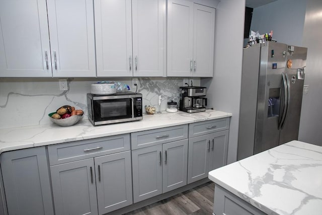 32 Leverett Rd, Shutesbury, MA 01072 - kitchen featuring stainless steel appliances, gray cabinetry, dark wood-style flooring, tasteful backsplash, and light stone countertops