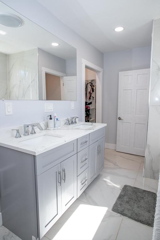 32 Leverett Rd, Shutesbury, MA 01072 - bathroom with double vanity, recessed lighting, marble finish flooring, and a spacious closet