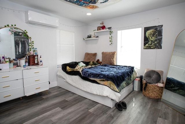 32 Leverett Rd, Shutesbury, MA 01072 - bedroom with a wall unit AC, dark wood-style floors, recessed lighting, and baseboards