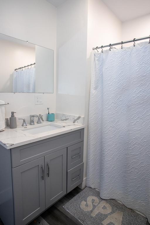 32 Leverett Rd, Shutesbury, MA 01072 - bathroom featuring wood finished floors, vanity, and a shower with curtain