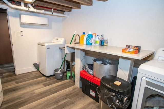 32 Leverett Rd, Shutesbury, MA 01072 - washroom with washer and clothes dryer, a wall unit AC, wood finished floors, and baseboards