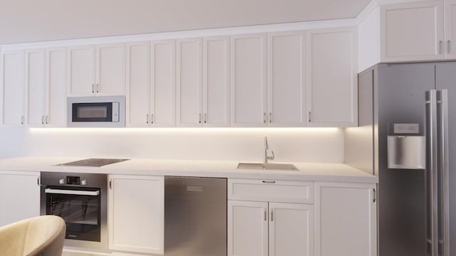 kitchen featuring a sink, light countertops, white cabinetry, and stainless steel appliances