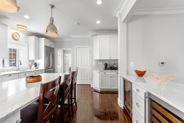 44 Sunset Ridge Ln Unit 44, Bolton, MA 01740 - kitchen featuring high end fridge, beverage cooler, a sink, crown molding, and a kitchen breakfast bar