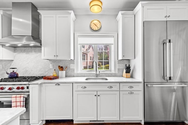 44 Sunset Ridge Ln Unit 44, Bolton, MA 01740 - kitchen featuring stainless steel appliances, wall chimney exhaust hood, a sink, white cabinetry, and ornamental molding